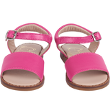 Girl wearing leather sandals with ankle strap – classic summer shoes