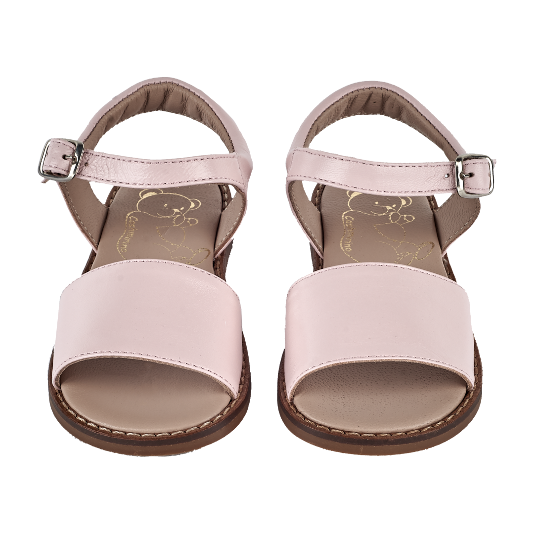 Girl wearing leather sandals with ankle strap – classic summer shoes