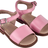 Girl wearing leather sandals with ankle strap – classic summer shoes