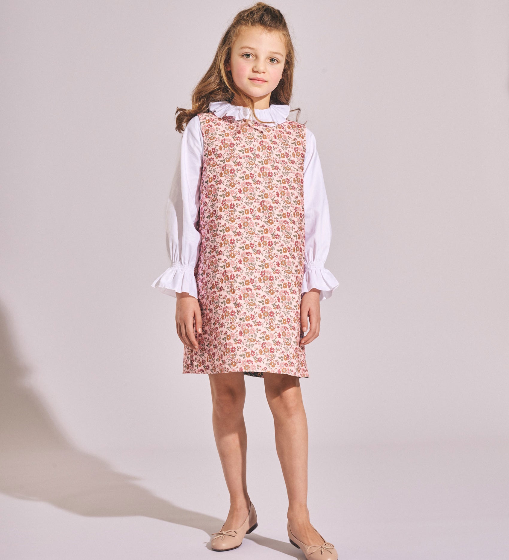 Girl wearing the Brigitte reversible Liberty Punk Meadows corduroy dress for an autumn day.