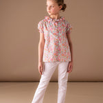 Girl wearing Liberty cotton blouse with trousers in summer