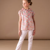 Girl wearing Liberty cotton blouse with trousers in summer