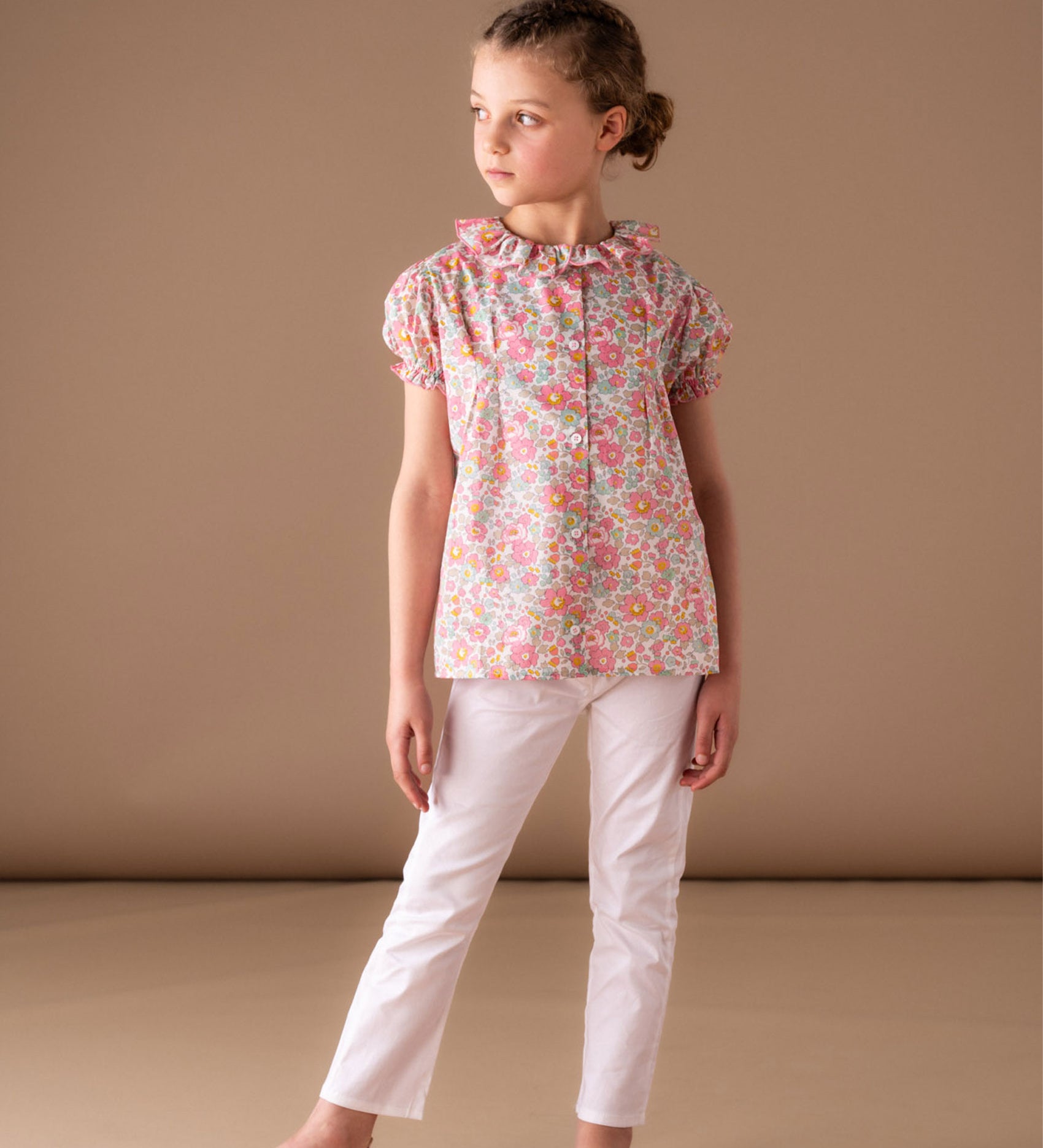 Girl wearing Liberty cotton blouse with trousers in summer