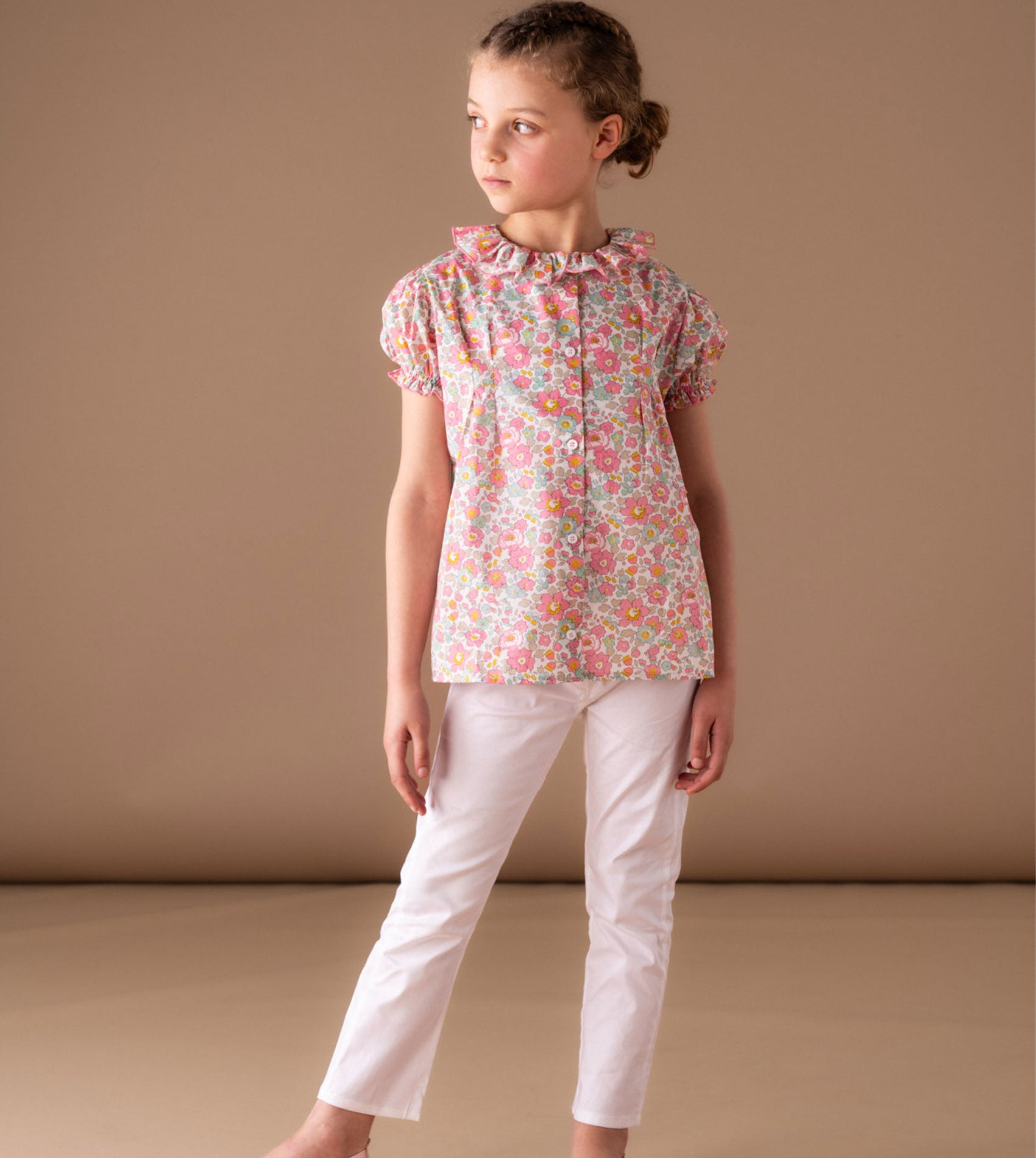 Girl wearing Liberty cotton blouse with trousers in summer